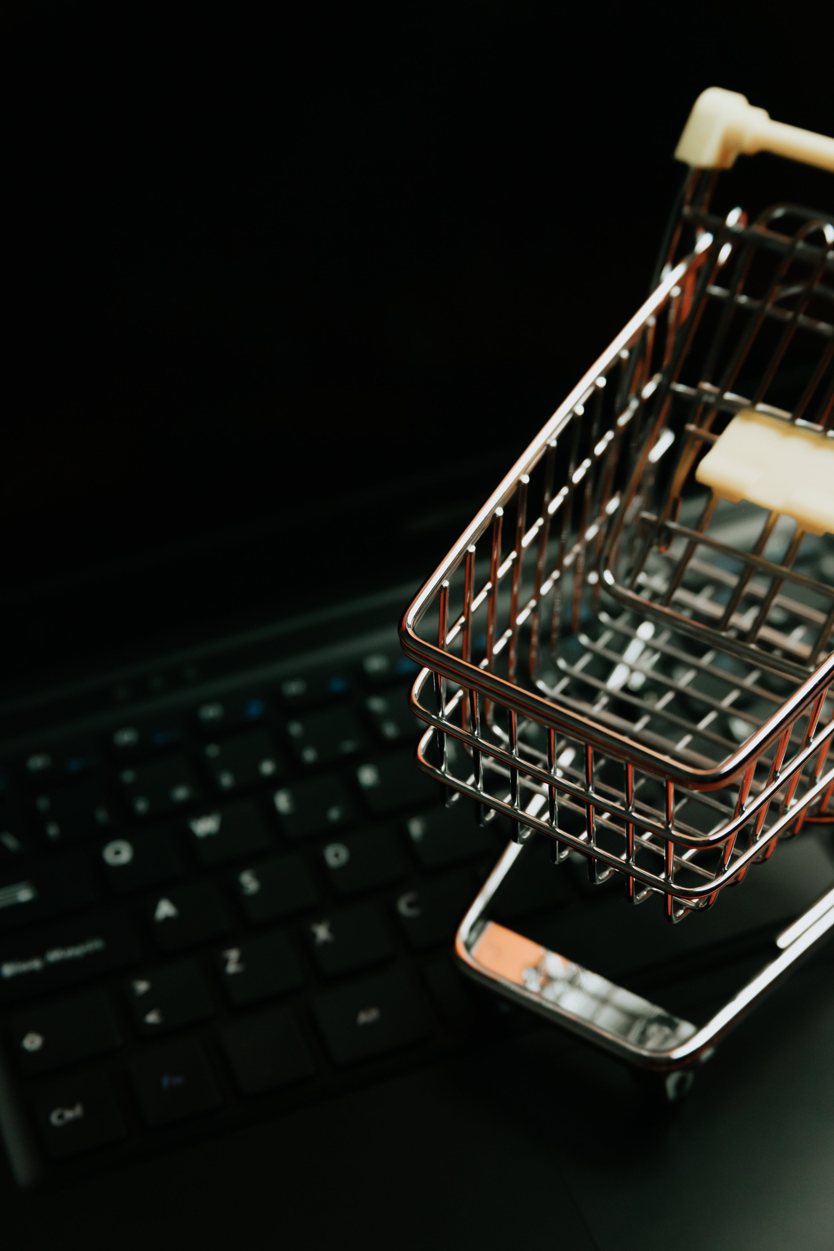Miniature Shopping cart and black keyboard