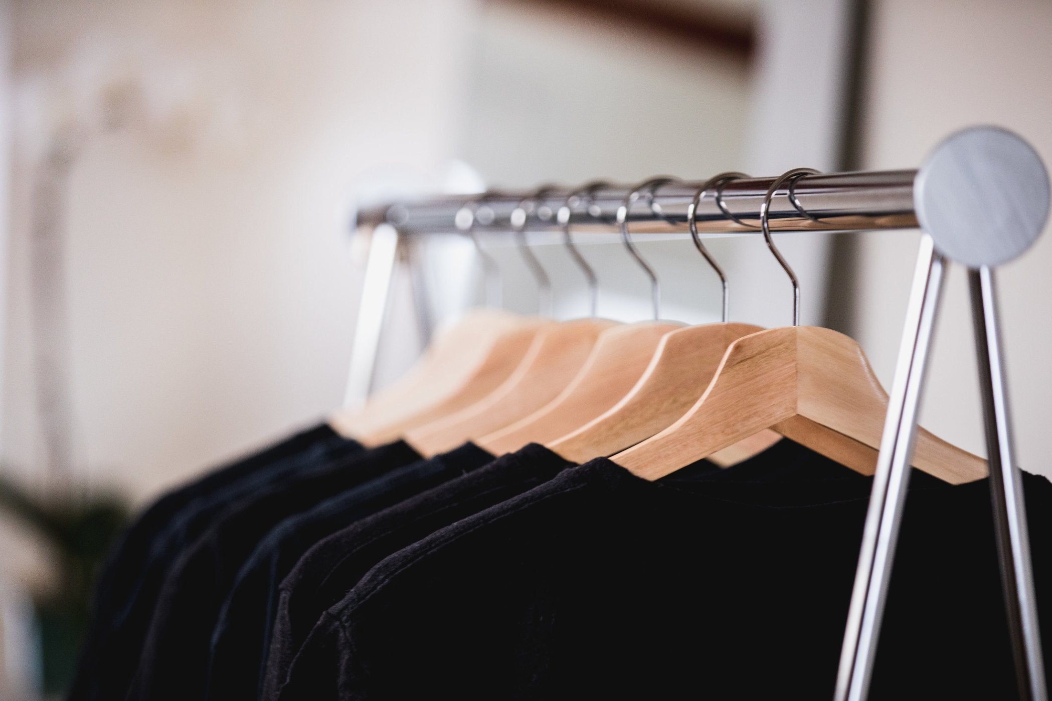 Metal clothing rack with shirts hanging