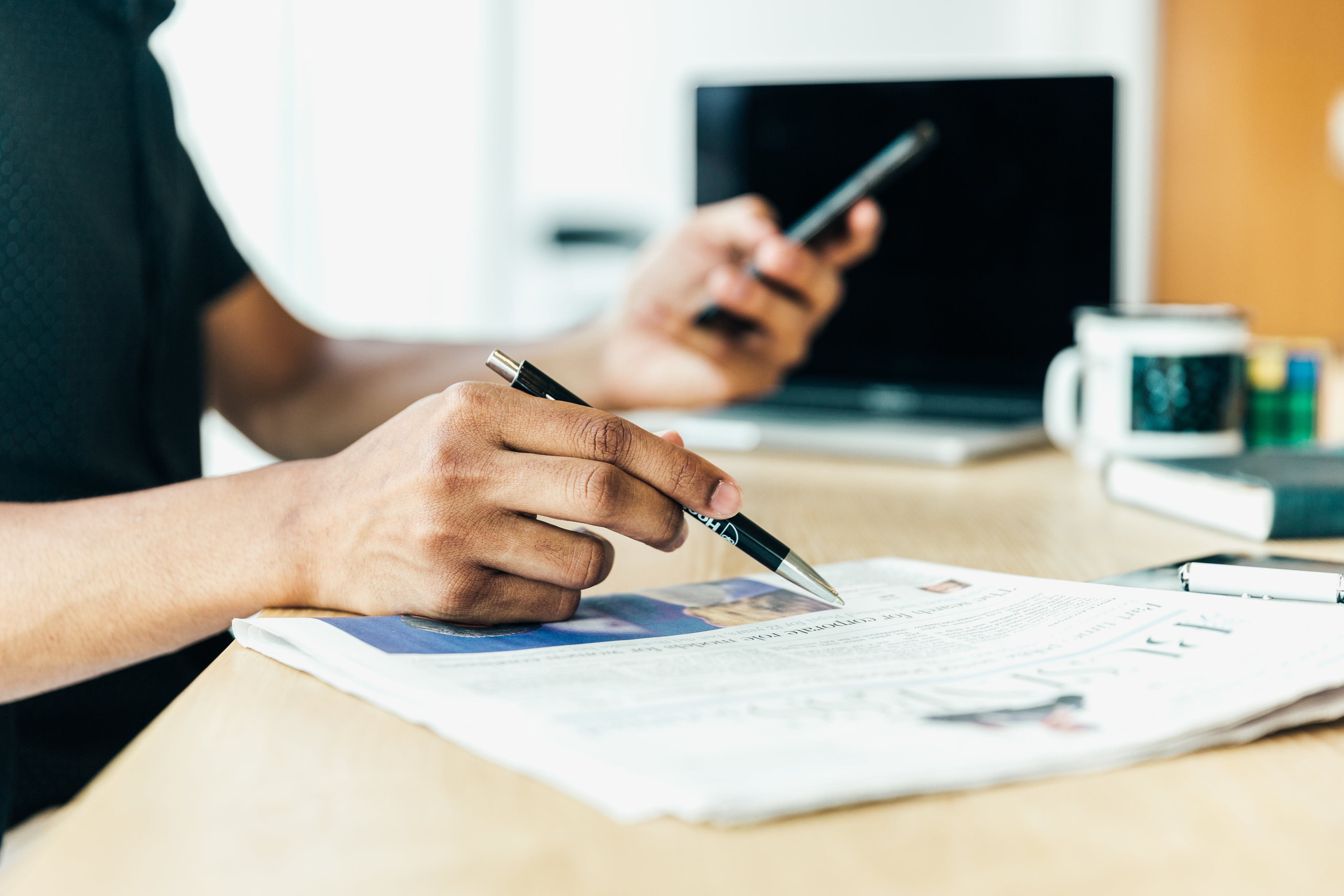 Man at desk with newspaper